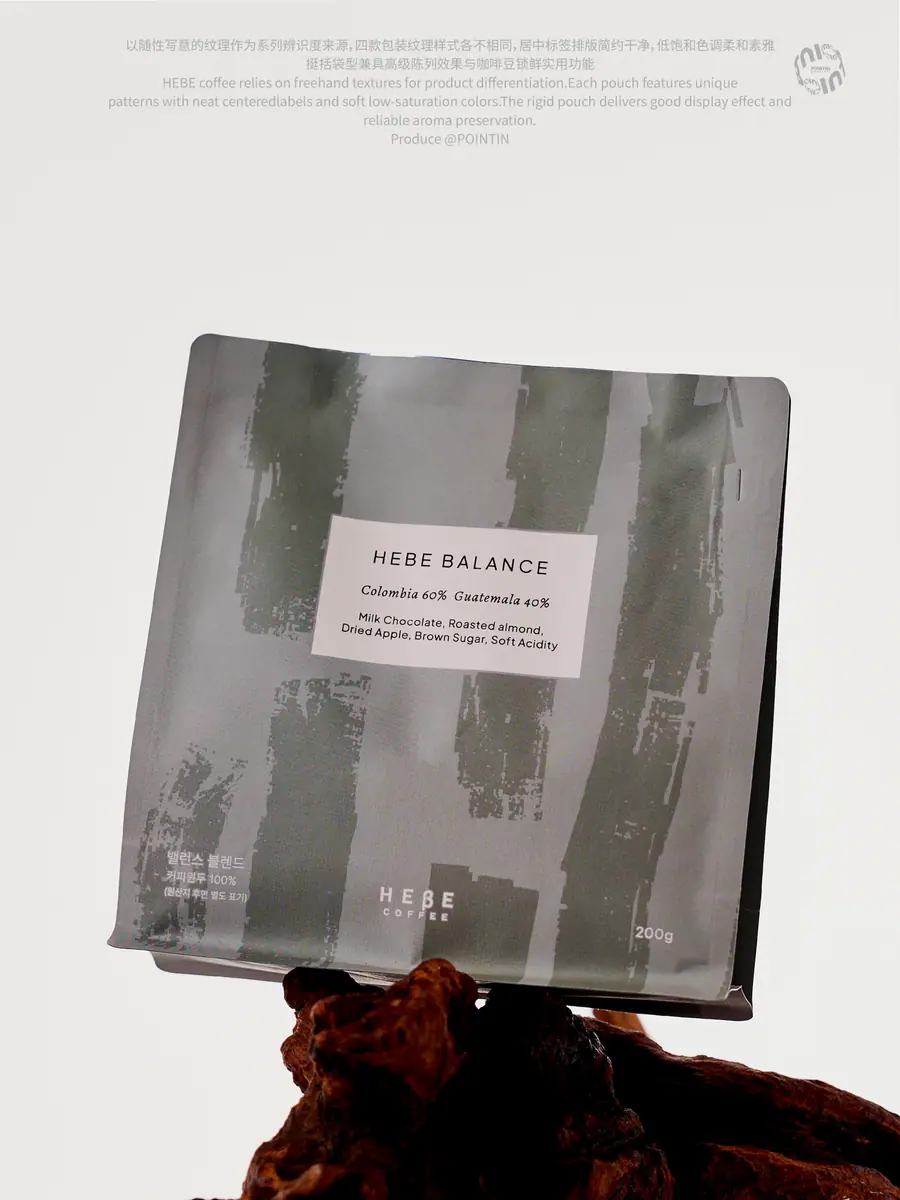 Grey coffee pouch balanced on a wood branch