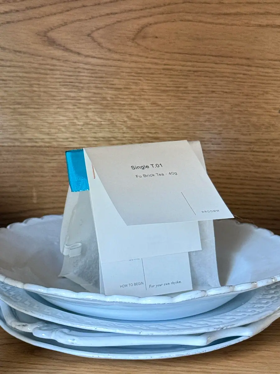 Printed tea pouch displayed on a plate