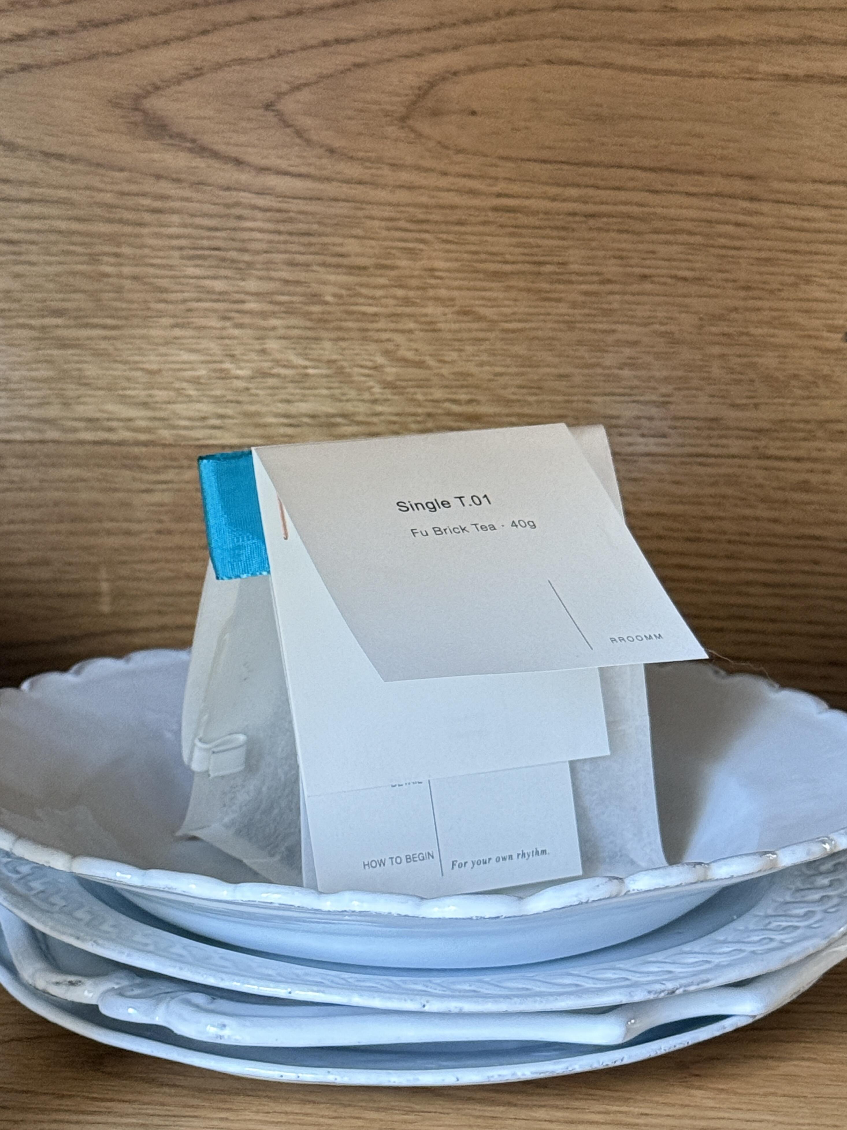 Printed tea pouch displayed on a plate